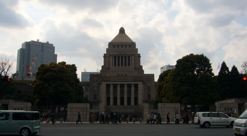 a tall building with a tower sits in the center of a city