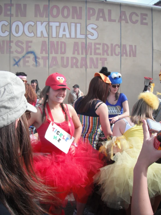 group of people dressed up in costumes, one of them showing signs