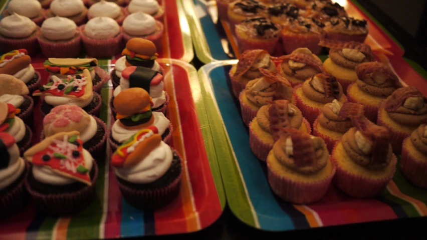 some trays with some cake and cupcake on it