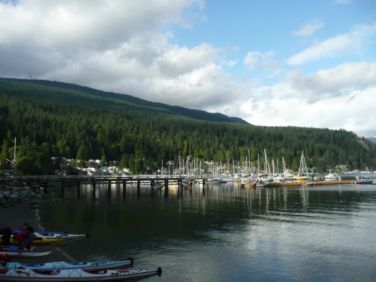 boats are tied up to the dock on the water