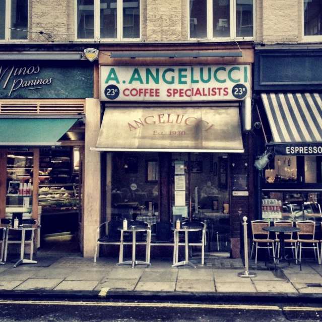 a shopfront with various coffee shops and chairs outside