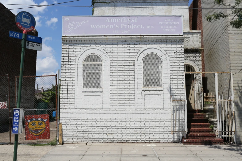 a white brick building with a blue street sign and a sign that says, martin street