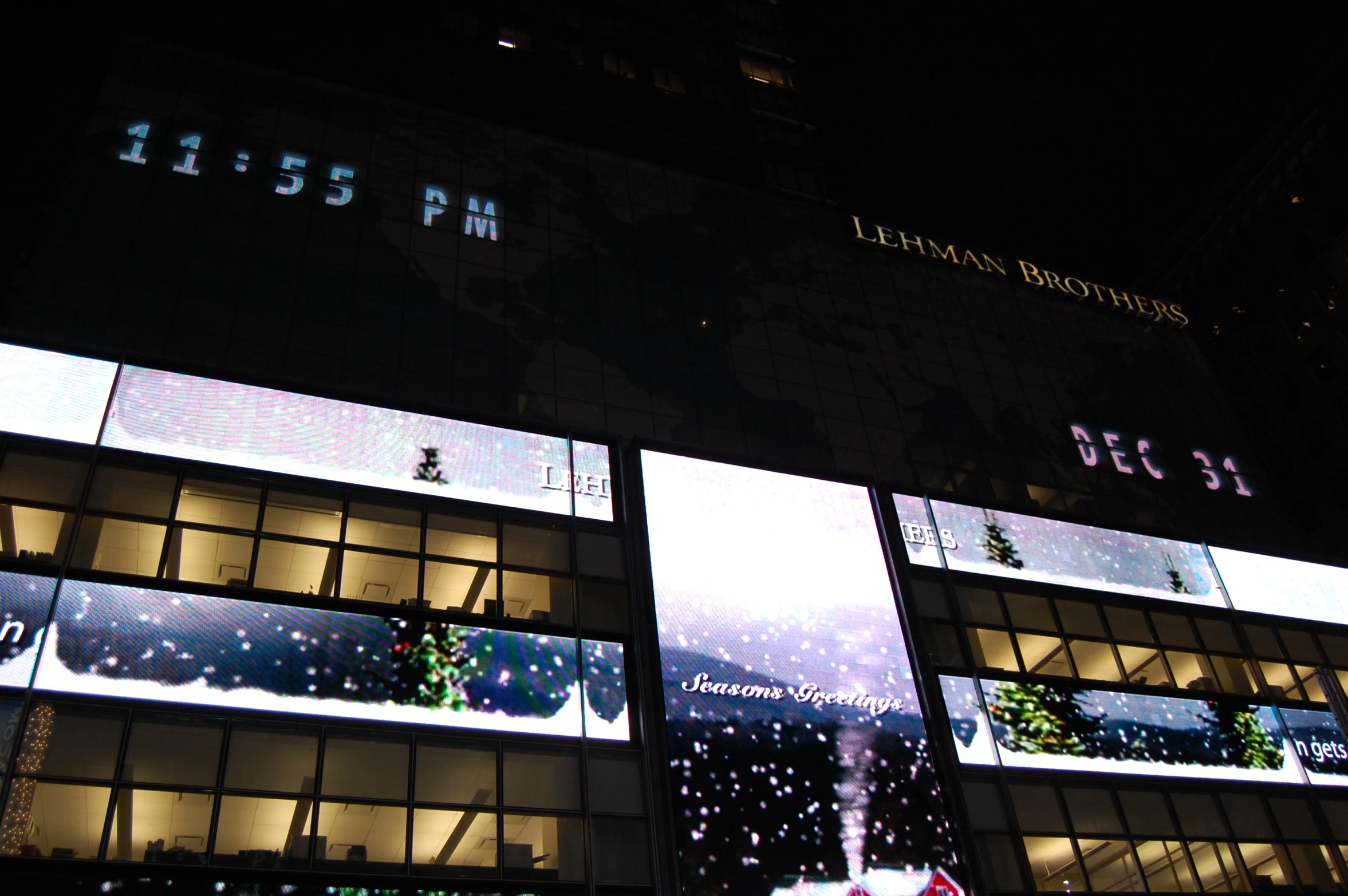 the side of a building lit up with lights and snow