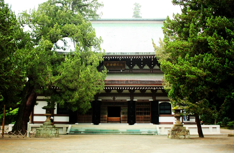 a very pretty house with some trees in front of it