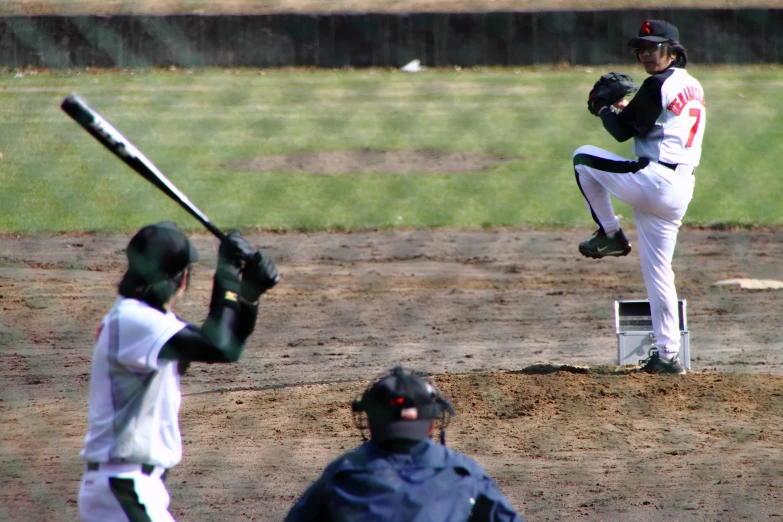 a man is pitching a baseball on a field