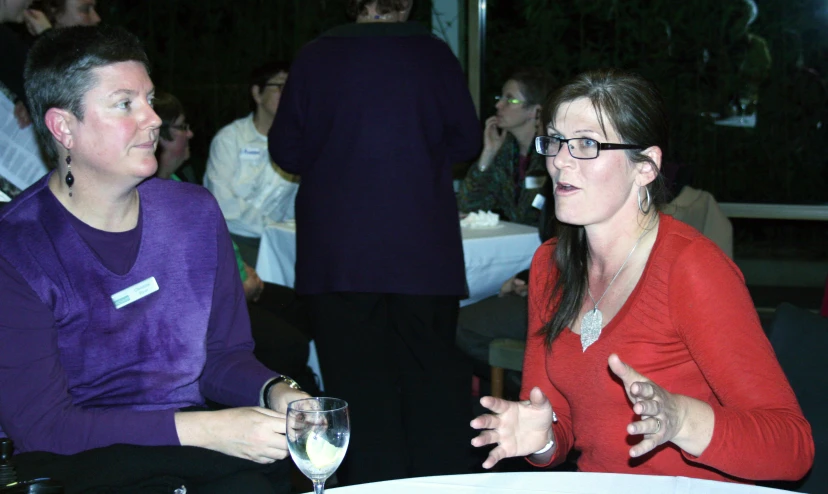 two people having wine and talking at an event