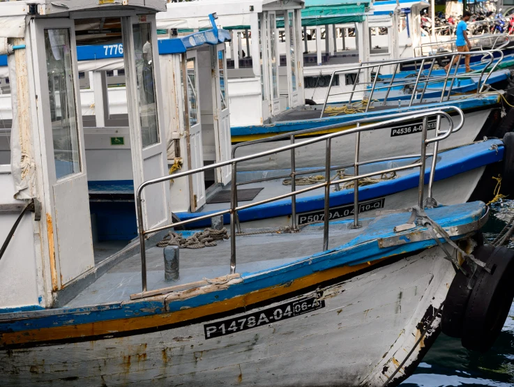 a row of white boats parked at a dock