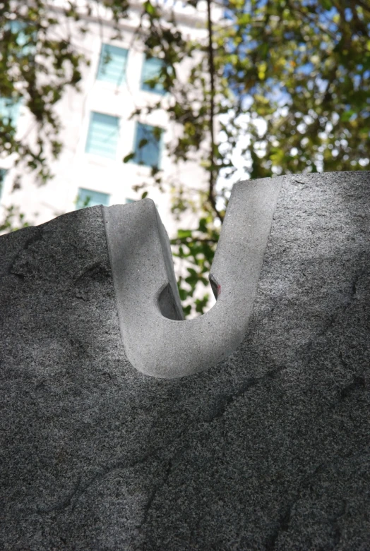 a large grey cement object that is shaped like a snail