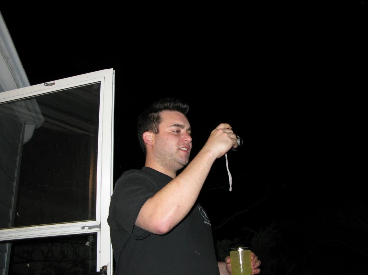 a man holding an object up in the air