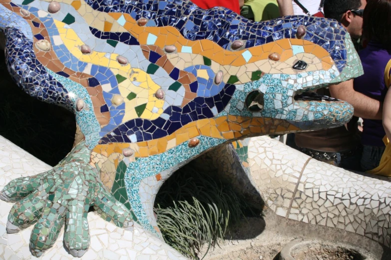 a ceramic lizard made out of mosaic tiles