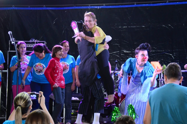 a man is dancing while surrounded by children