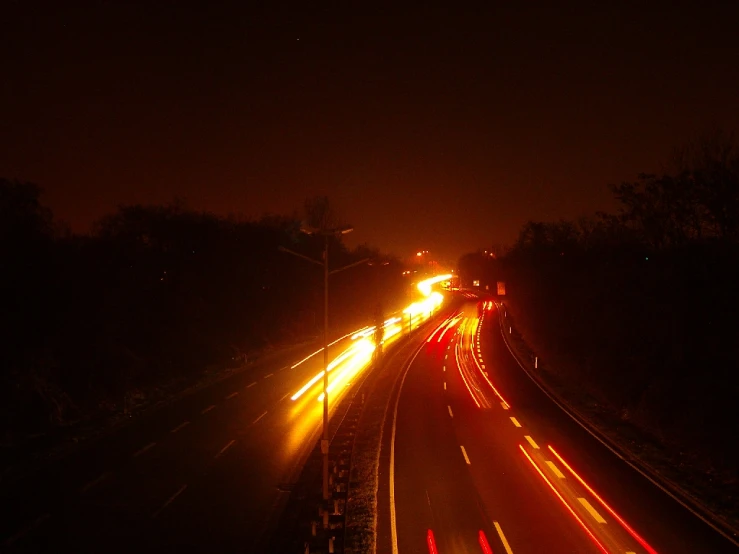 a long exposure of an approaching traffic with red lights