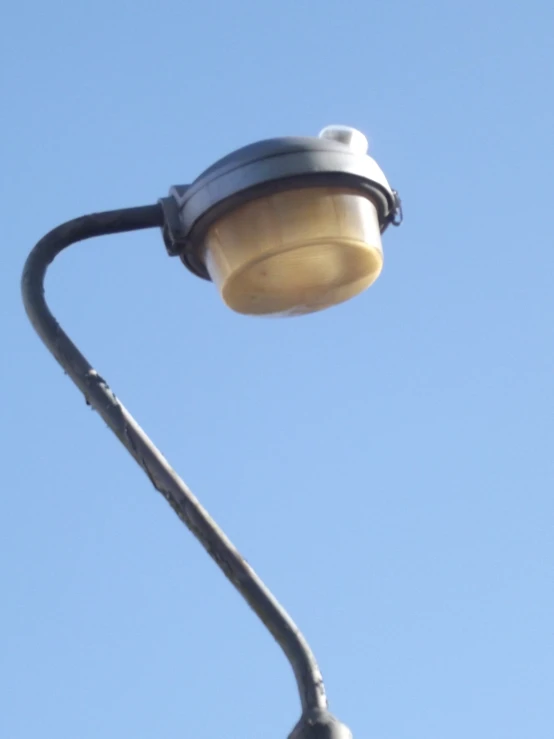 a street lamp sits on the side of a road