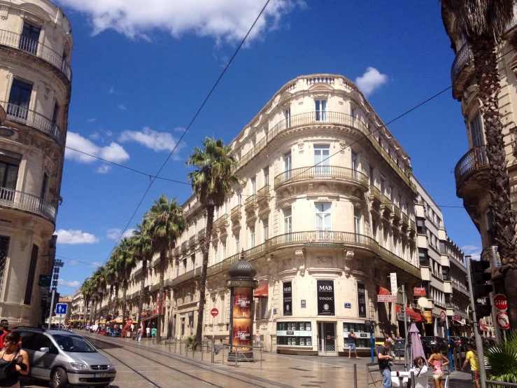 a street corner with many stores and cars on it