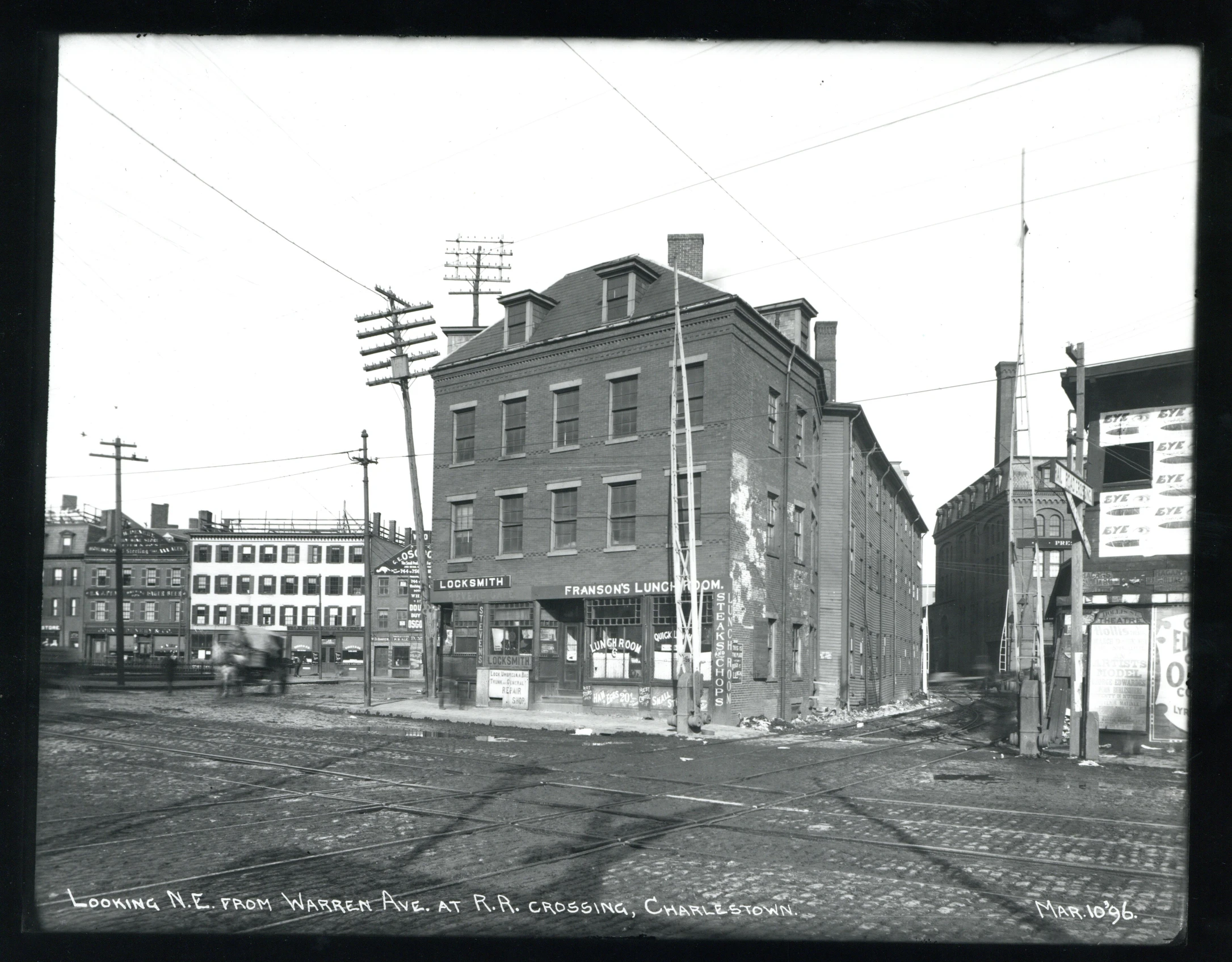 a black and white po of an old building and train tracks