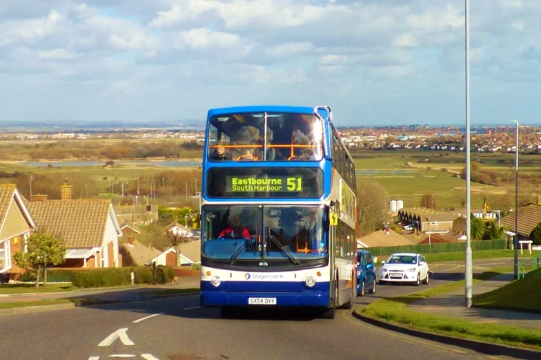 double decker bus on city street with cars