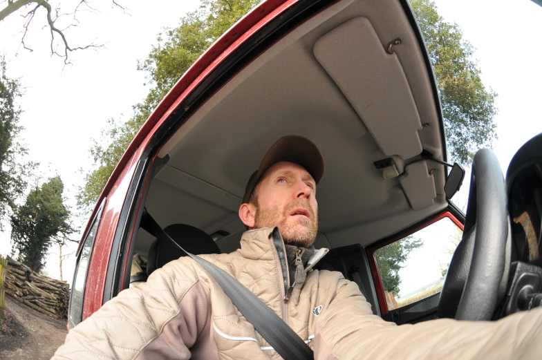 a man sitting inside the driver's seat of a van