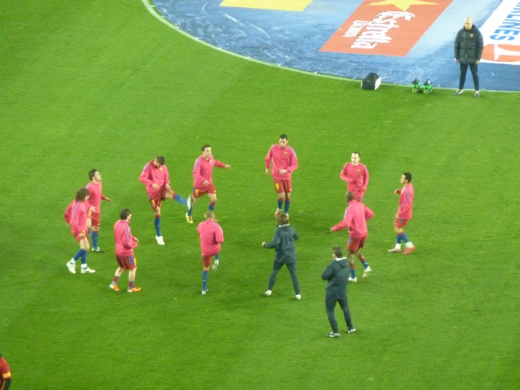 a soccer team on the field and some coaches