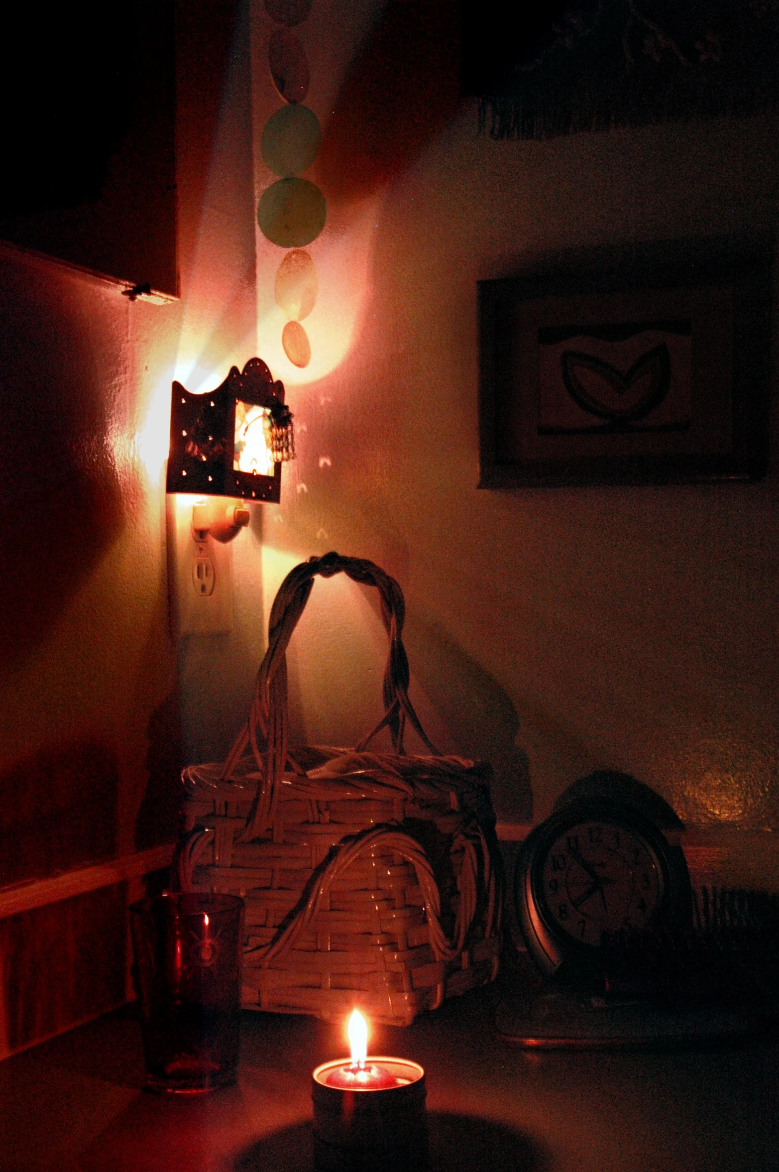 a lighted candle in front of a bag on the table