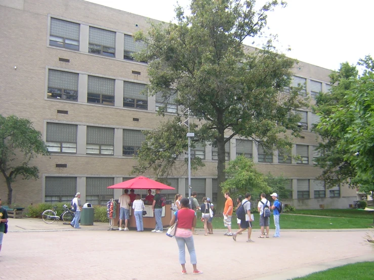 a bunch of people walking around with some red umbrella