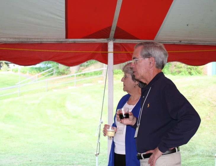 an older couple enjoying a wine at a party