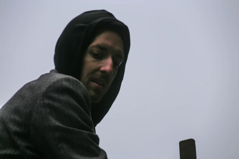 a man is standing in front of a cross