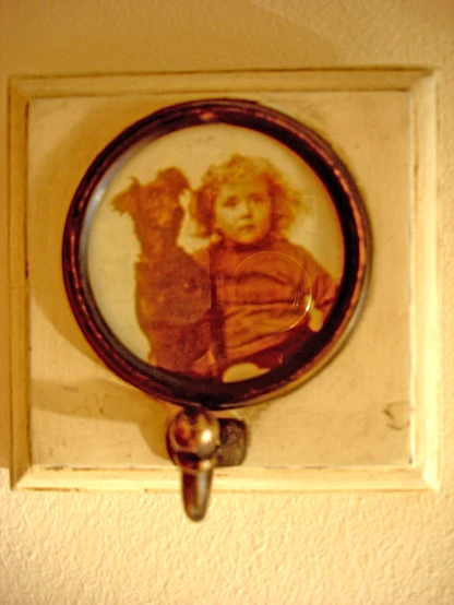 there is a frame with a picture of an older child and a little dog