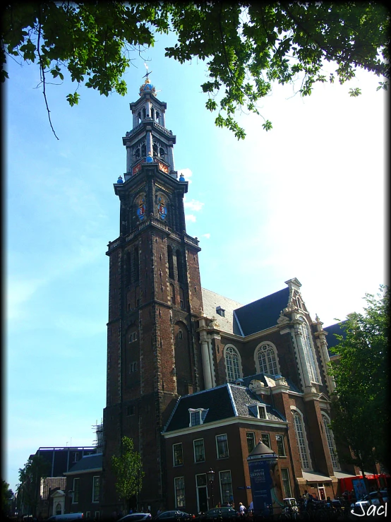 an old, tall building with a clock tower next to trees