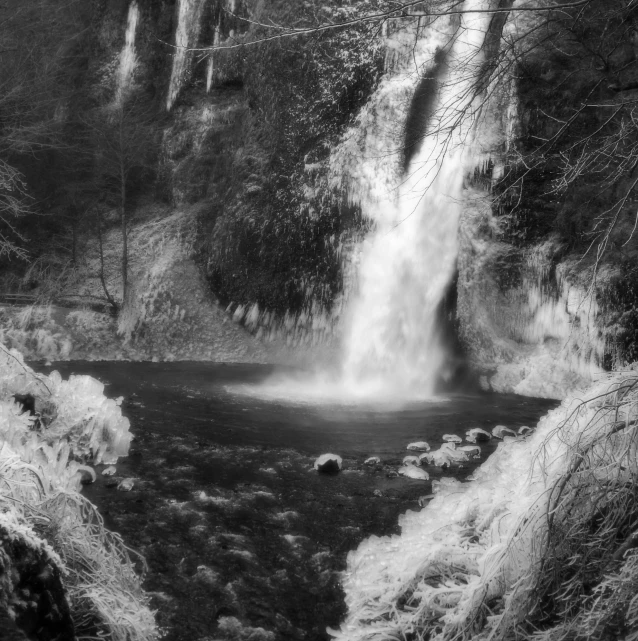 an alpine waterfall in black and white