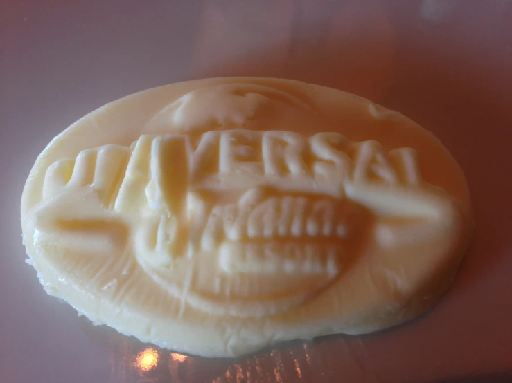 a small waxed seal with the words universal written across it