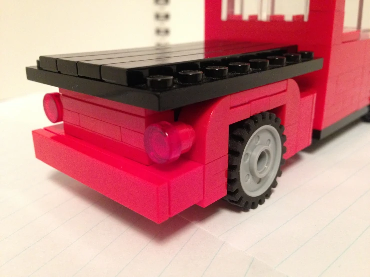 a red lego truck sitting on top of a table