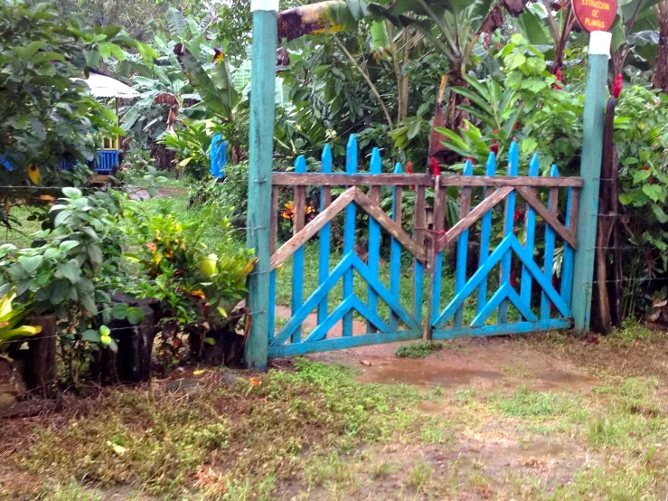 a blue gate with a sign saying this is not the entrance