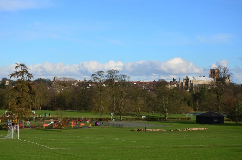 a soccer field with people playing in the distance