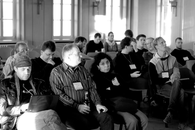 black and white image of people sitting in a church