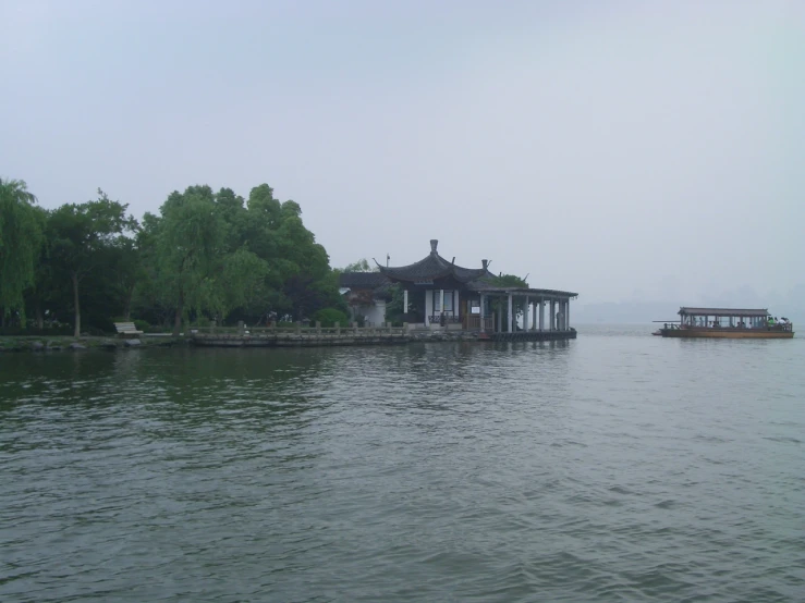 a barge on water next to a pier and a building