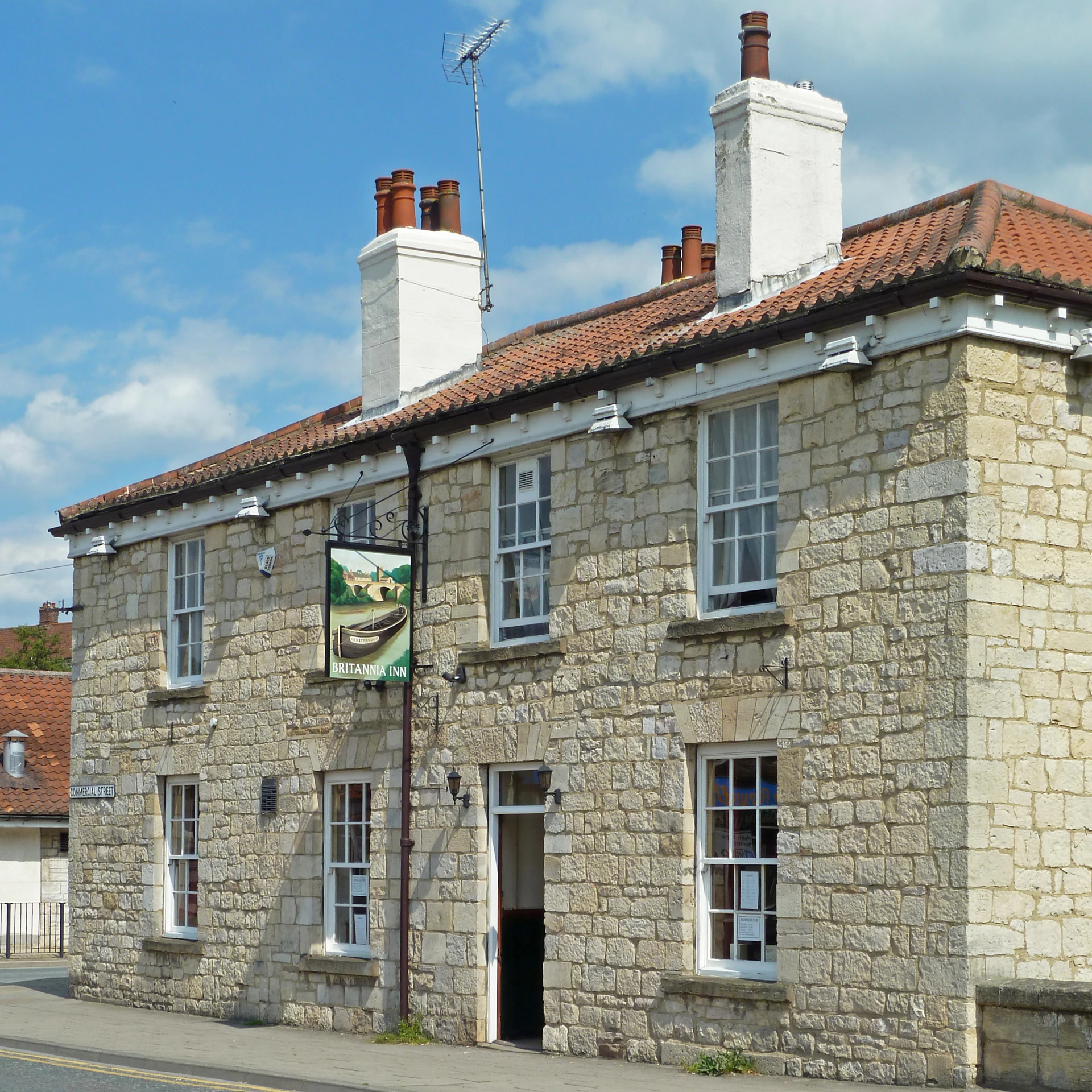 an old building is shown with a flag on the roof