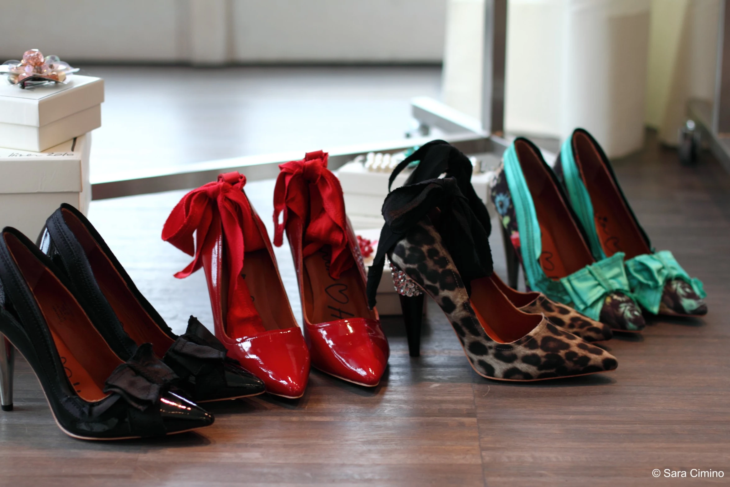 eight pairs of heels that have bows on them