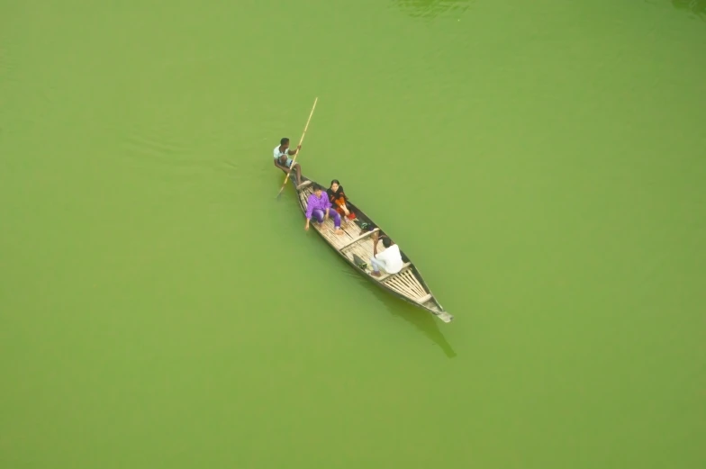 an aerial view of two people row a boat