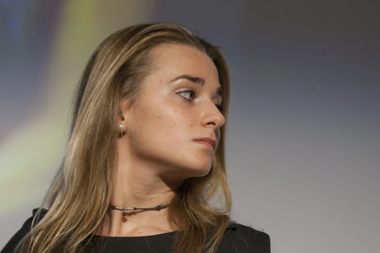 a close up of a person wearing necklaces