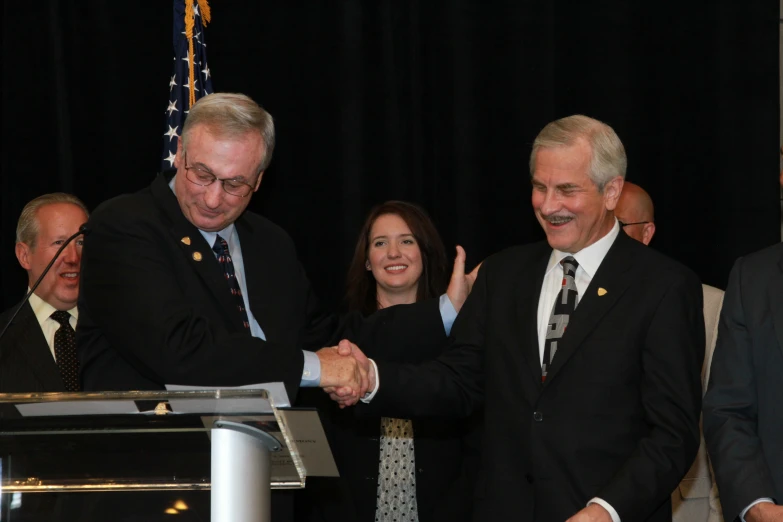 three people greeting each other in a business meeting