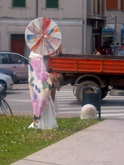 a couple taking pictures with a colorful umbrella in a city
