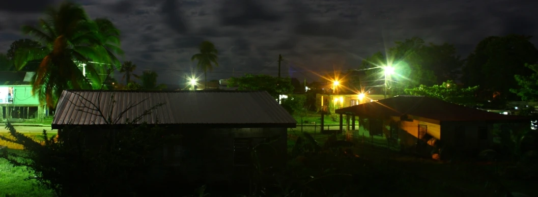 a city view at night with lights reflecting off of the road