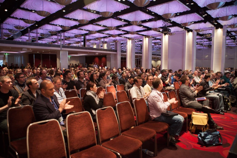 people are sitting in chairs during an audience