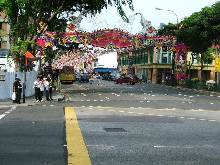 a couple of people are walking under a decoration archway