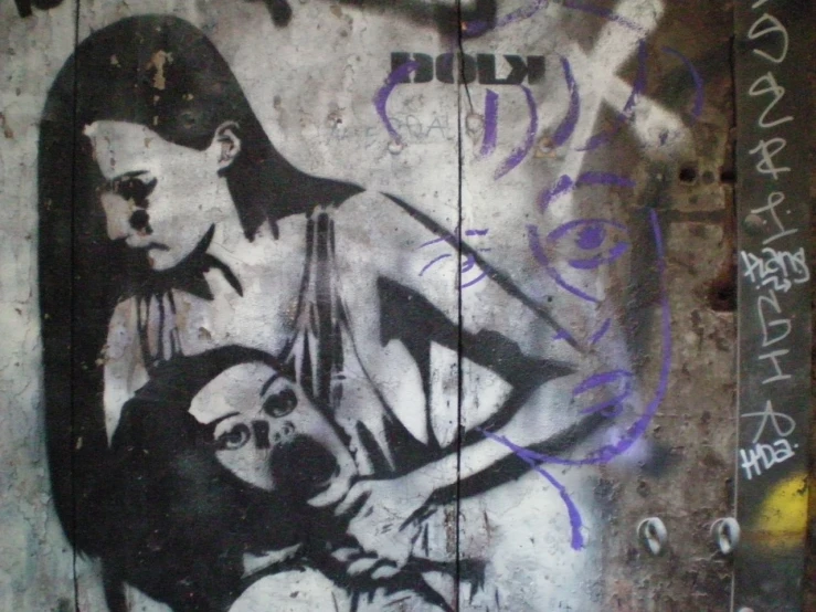 graffiti painted on a wall of a woman and child