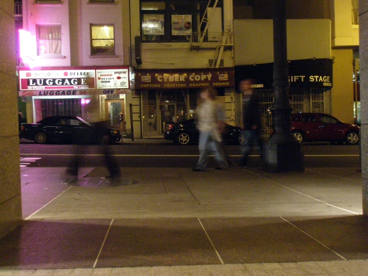 a couple of men that are standing on a sidewalk