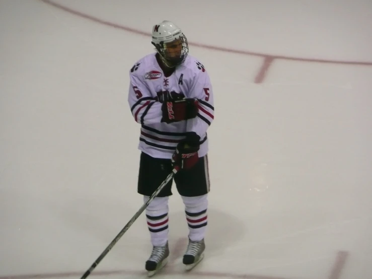 the hockey player is on the ice waiting for the ball