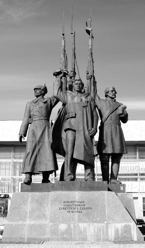 a group of people standing next to a statue