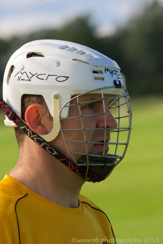 close up view of a professional lacrosse helmet and a sports team's jersey