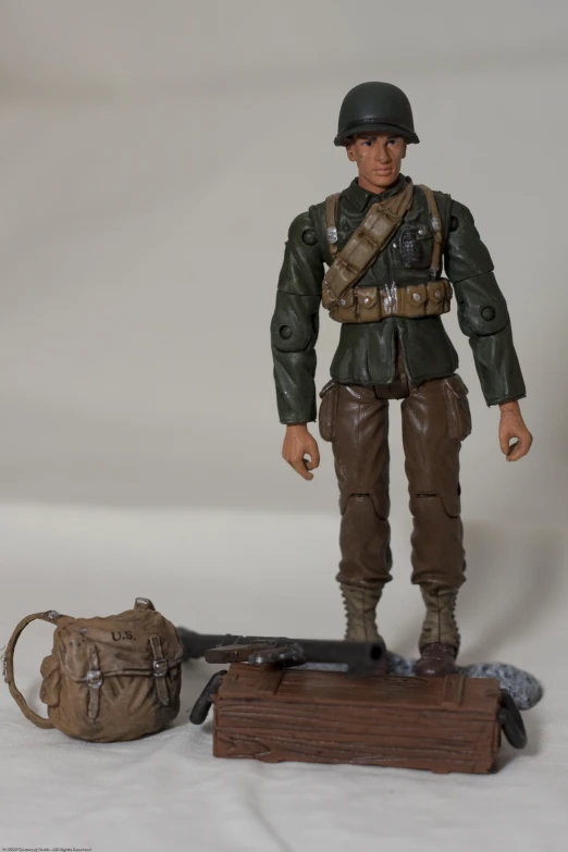 an action figure of a man standing next to a bag